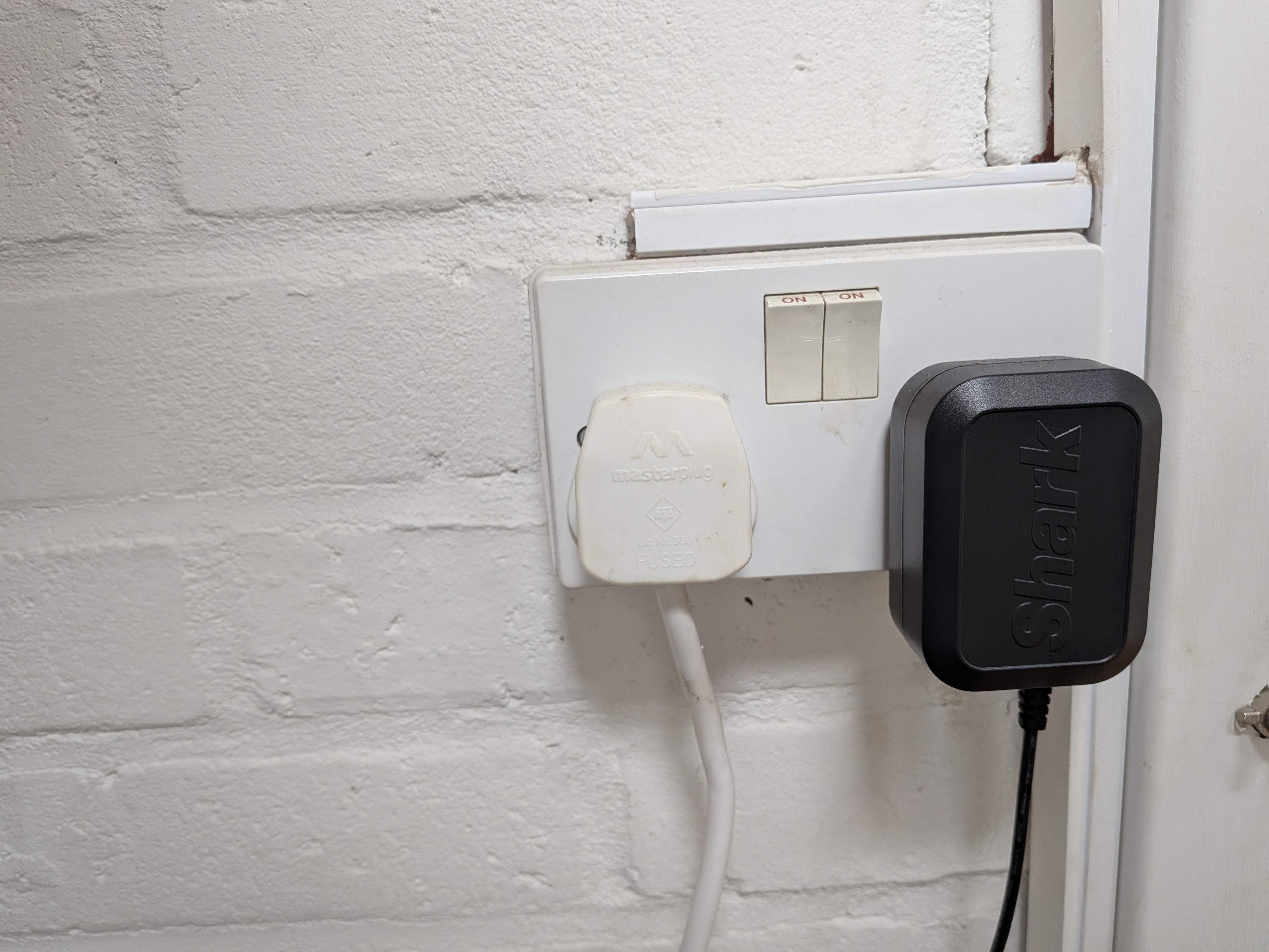 Double socket in utility room showing the white boiler plug on the left
